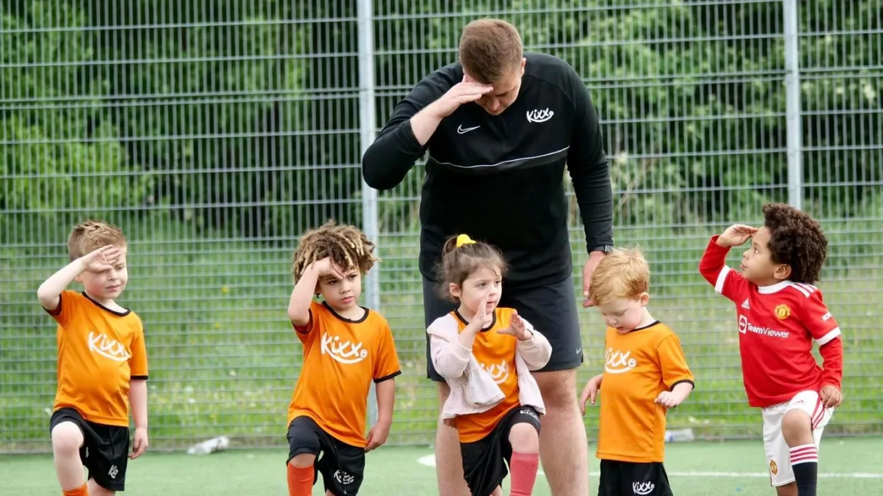Coach leading structured toddler football classes with fun skill-based activities