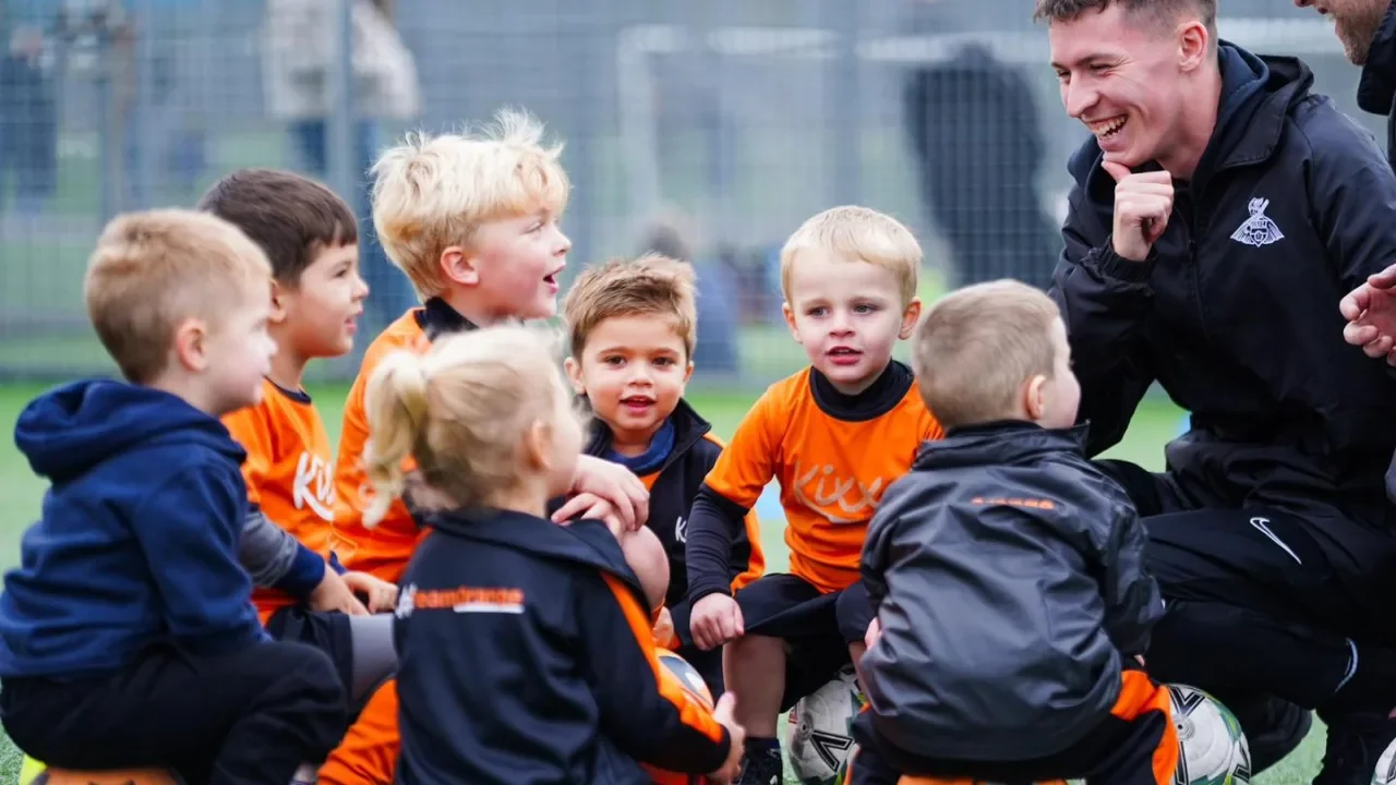 Parents and young children benefiting from engaging toddler football classes