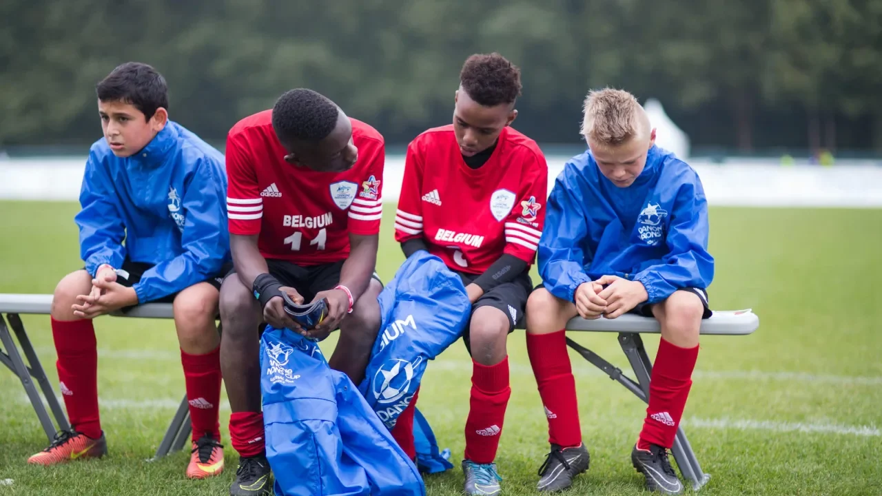 Youth team manager leading players within a community football club structure